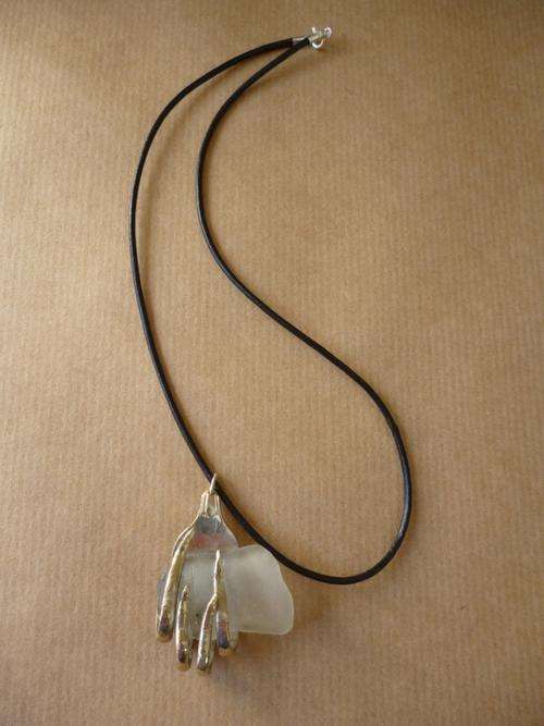 Sea Glass Necklace With Silver Plate Bezel. Leather strap with silver clasp and ends.